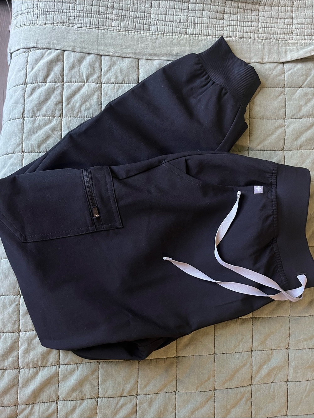 FIGS Zamora Jogger Scrub Pants in Black with a contrast Light Grey Drawstring